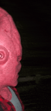 a close up of a person 's face with a pink mask on