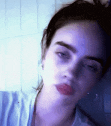a close up of a woman 's face with red lips