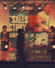 a store window with a sales story advertisement