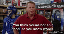 a man is standing in front of a sign that says louisville slugger