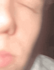 a close up of a person 's face with a blurred background