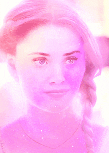 a close up of a woman 's face with a purple glow