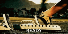 a person is getting ready to run on a track with the word ready in the foreground
