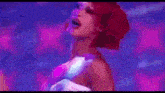 two women are dancing on a stage in front of a crowd .