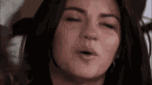 a close up of a woman making a funny face with her mouth open .