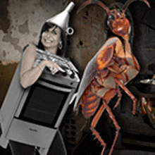a woman in a cockroach costume is holding a stove