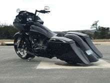 a black harley davidson motorcycle with a texas license plate is parked on the side of the road