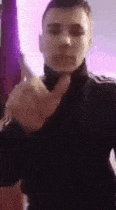 a young man is giving the middle finger in a video .