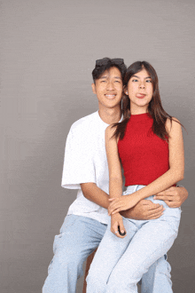 a man and a woman are posing for a picture with the woman sticking her tongue out