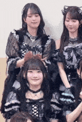 a group of young women are posing for a picture together . one of the girls is wearing a cat ear headband .