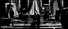 a black and white photo of a man walking in a room .