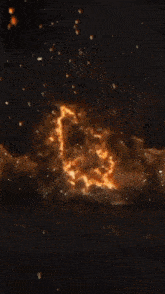 a large explosion with smoke coming out of it in the dark