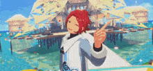 a man with red hair is pointing at something in front of a beach house