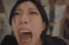 a close up of a woman 's mouth with her eyes closed .