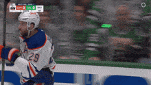 a hockey player with the number 29 on his jersey stands on the ice