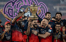 a group of men holding a trophy with qatar airways written on their shirts