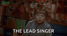 a little girl in a wig is saying the lead singer in a christmas movie .