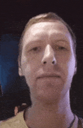 a close up of a man 's face with his eyes closed and his mouth open .