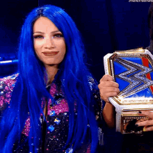 a woman with long blue hair is holding a wrestling championship belt