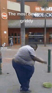 a man is standing in front of a building with a sign that says ' the most devired griddy '