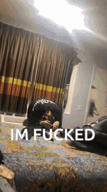 a man laying on a bed with the words im fucked written on the bottom