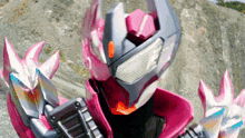 a close up of a robot with a pink helmet on