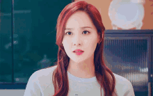 a woman with red hair is wearing a white shirt with the word star on it