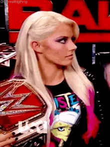 a woman with blonde hair is wearing a t-shirt that says " rise "