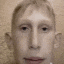 a close up of a man 's face with a blurred background