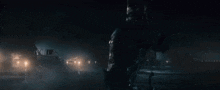 a woman in a wonder woman costume stands in a dark room