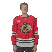 a man wearing a chicago blackhawks jersey with coca-cola sports written on the front