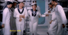 a group of sailors are dancing in front of a screen that says cinema 3 on it