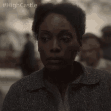 a close up of a woman 's face with the hashtag #highcastle on the bottom right