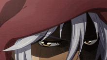 a close up of a person 's eyes with a red hood on