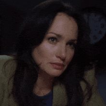a woman is crying in front of a clock that shows the time as 9:45