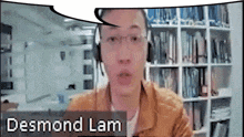 a man wearing headphones and glasses with the name desmond lam on the bottom