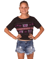 a young girl wearing a black crop top and denim shorts is standing with her hands on her hips .