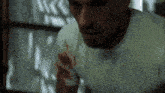a man wearing a white shirt with blood on his arm