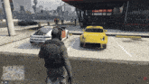 a man in a video game is standing in front of a yellow car that says ' a ' on the side