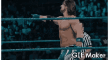 a man in a wrestling ring with the words gif maker on the bottom right
