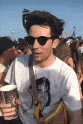 a man wearing sunglasses and a white t-shirt that says wallets