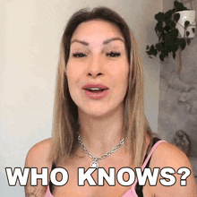 a woman wearing a pink tank top and a necklace says who knows