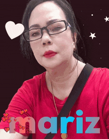 a woman wearing glasses and a red shirt with mariz written in blue