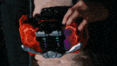 a man in a dark room with a red light coming from his chest