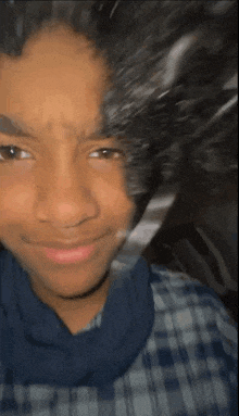 a close up of a person 's face with their hair blowing in the wind