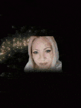 a woman with a crown on her head is surrounded by gold lights .