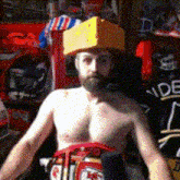 a shirtless man wearing a yellow hat with the letter d on the front