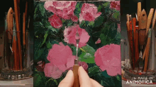 a painting of pink flowers is being painted on a canvas