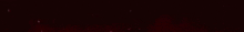 a close up of a red light beam on a dark background .