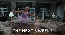a man in a purple tutu is dancing with a little girl in a living room with the next 6 weeks written in the corner